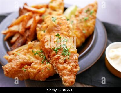 Pesce fritto in pastella croccante con patatine tagliate a mano Foto Stock