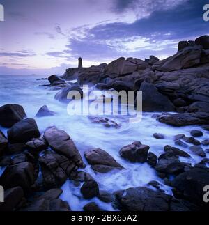 Faro sopra il mare tempestoso sulla Costa di granito Rosa, Ploumana`h, Cotes d`Armor, Bretagna, Francia Foto Stock