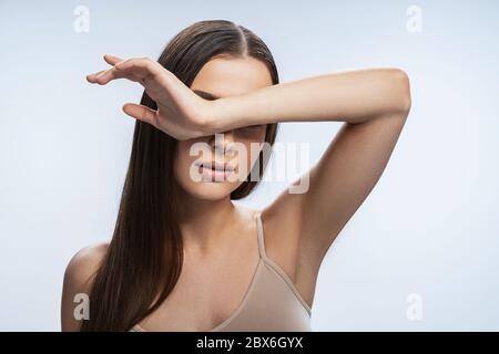 Femmina con la bocca leggermente aperta in piedi in interni Foto Stock