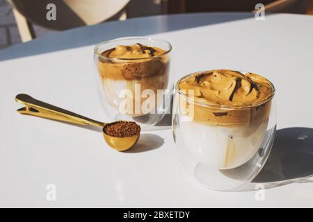 Dalgona Coffee, un caffè frizzante e cremoso alla moda in tazze di vetro Foto Stock