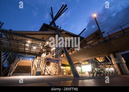 Foto notturna della stazione della U-bahn di Neue Mitte, affascina lo stile architettonico con un tetto e una struttura a colonne eccezionali di fronte al Centro in Germania Foto Stock