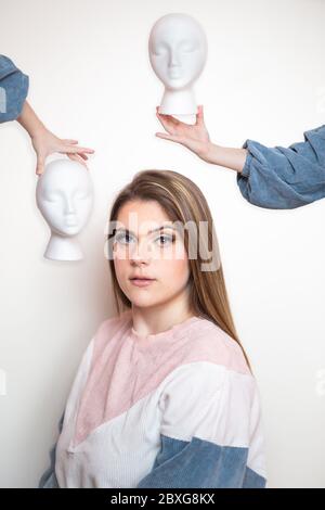 Ritratto di una donna e due teste manichino Foto Stock