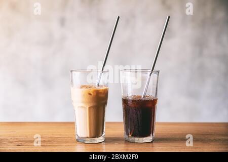 Due bicchieri di caffè ghiacciato con cannuccia in acciaio inox su tavolo di legno Foto Stock