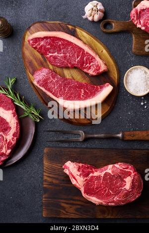 Vista dall'alto varietà di freschi Black Angus prime carne di manzo: ribeye, striploin, mandrino e picanha su tavole da cutiing Foto Stock