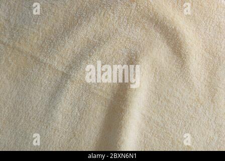 Tessuto e tessuto, primo piano di asciugamano di cotone di Beige ondulato o di tessuto di Terry sfondo con Copy Space per la decorazione del testo. Foto Stock