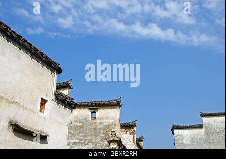 Città antica di Xidi nella provincia di Anhui, Cina. Tetti tradizionali e pareti bianche nel centro storico di Xidi, adagiato su un cielo blu Foto Stock