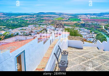 Osserva la città bianca (pueblo blanco) di Arcos dal punto di vista della terrazza di Abades; guarda i tetti in tegole di vecchie case sul pendio collinare, verde valle Guadalete Foto Stock