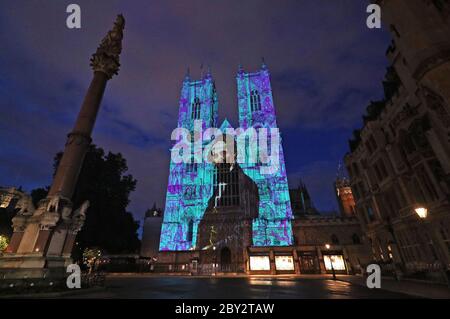 Un'immagine di Charles Dickens è proiettata sulle West Towers of Westminster Abbey a Londra per celebrare il 150° anniversario (martedì) della morte di uno dei più grandi autori della nazione. Il Decano di Westminster, il reverendo Dr David Hoyle, deporrà una corona e dirà preghiere alla tomba dello scrittore nel transetto sud dell'Abbazia. Foto Stock