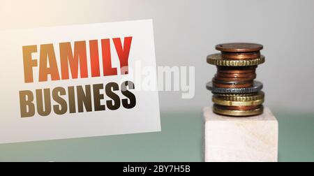 Business della famiglia su una carta e una pila di monete. Moduli aziendali e concetto legacy Foto Stock