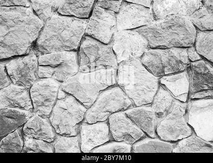 Parete di pietra grigia. Strada acciottolata naturale, sfondo di alto dettaglio, sfondo in pietra. Foto Stock