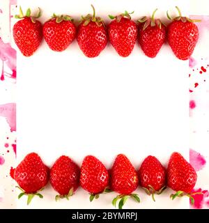 Fragola rossa brillante con macchie acquerello su bianco. Foto Stock