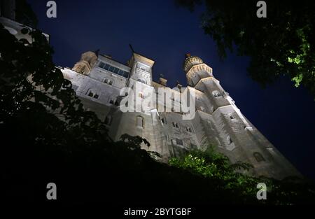 Schwangau, Germania. 10 Giugno 2020. Alla luce di 47 faretti a LED, il Castello di Neuschwanstein è in piedi sotto la pioggia. La conversione al nuovo sistema di illuminazione costa 300,000 euro. I faretti non solo dovrebbero fornire una luce migliore, ma anche essere più insetto-friendly e risparmiare energia elettrica. Credit: Karl-Josef Hildenbrand/dpa/Alamy Live News Foto Stock