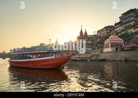 Una nave da crociera sul fiume si trova ancorata nei Ghati di Benaras, una città dove la gente viene per realizzare la salvezza. Foto Stock