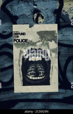 Un segno è inviato chiedendo di definanziare la polizia durante la protesta nera vite materia. Foto Stock