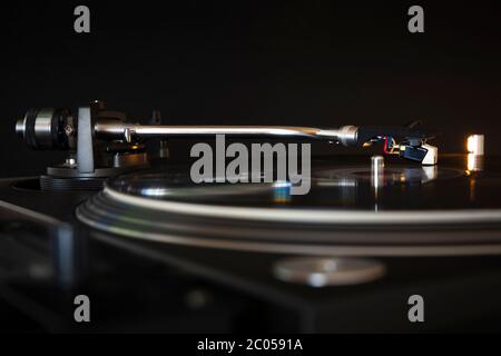 Disco in vinile che gira su un moderno giradischi. Sfondo nero. Spazio per il testo. Riproduci il concetto musicale. Foto Stock