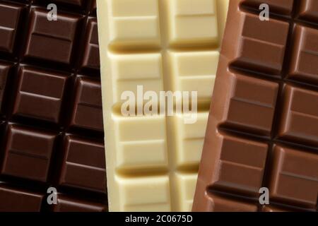 Tutta la barra di cioccolato bianco, scuro e latte si avvicina alla cornice completa Foto Stock