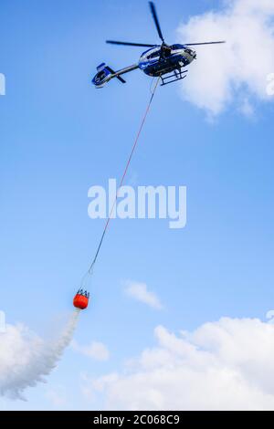 Elicottero di polizia Airbus H 145 durante l'esercizio con serbatoio d'acqua fuoco BAMBI SECCHIO, Düsseldorf, Nord Reno-Westfalia, Germania, Europa Foto Stock