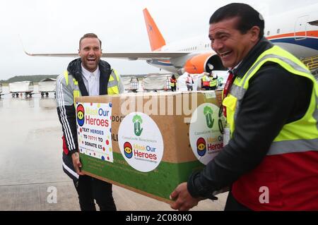 Calum Best (a sinistra) e Tamer Hassan aiutano a scaricare scatole di dispositivi di protezione personale (PPE) da un aereo all'aeroporto Robin Hood di Doncaster, nello Yorkshire del Sud. ??30,000 il valore di PPE è stato donato alla carità Mask Our Heroes, che è stata istituita dall'imprenditore Matthew McGahan sulla scia dell'epidemia di coronavirus per aiutare a fornire i dispositivi di protezione di cui hanno bisogno ai lavoratori della prima linea NHS e della salute. Foto Stock