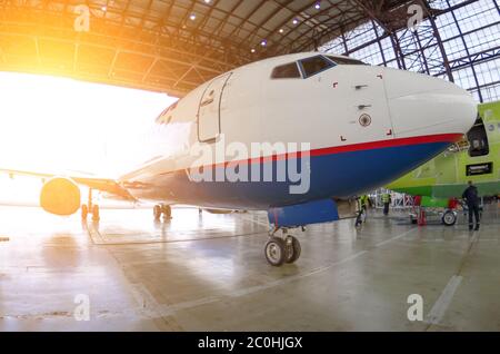 Dopo la riparazione, l'aereo viene arrotolato dall'hangar con un trattore dell'aeroporto Foto Stock