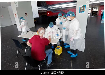 Bucarest, Romania. 10 Giugno 2020. Un uomo riceve test di anticorpi COVID-19 presso un centro di test nello stadio di calcio della National Arena di Bucarest, Romania, 10 giugno 2020. Il primo ministro rumeno Ludovic Orban ha annunciato a fine giovedì un nuovo ciclo di relax delle restrizioni COVID-19, tra cui la riapertura di centri commerciali, sale da gioco e piscine all'aperto a partire da giugno 15. Credit: Cristian Cristel/Xinhua/Alamy Live News Foto Stock