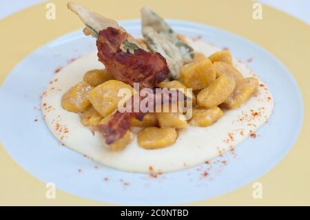 Gnocchi con burro di zucca e arachidi e pancetta croccante Foto Stock