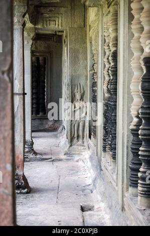 Interno della Galleria Nord dell'antico tempio Khmer Angkor Wat, Siem Reap, Cambogia. Le barre del finestrino in pietra tornito si trovano sul lato destro, a c Foto Stock