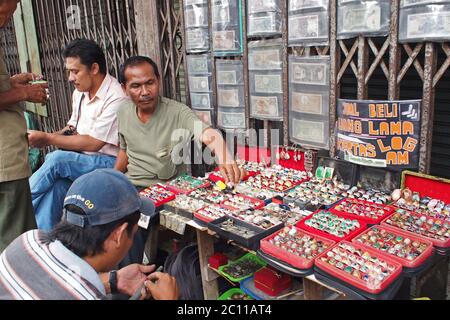 Bogor, Giava Occidentale, Indonesia - 28 Dicembre 2013 : commercianti antichi che vendono sul marciapiede, anelli peddling, agata e soldi antichi Foto Stock
