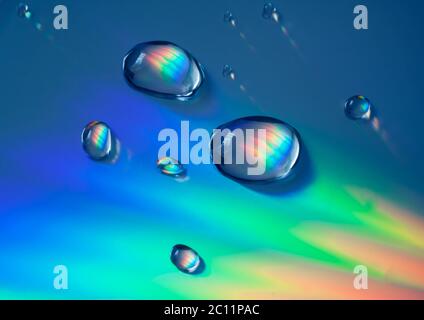 Primo piano di riflessi arcobaleno e gocce d'acqua su CD Foto Stock