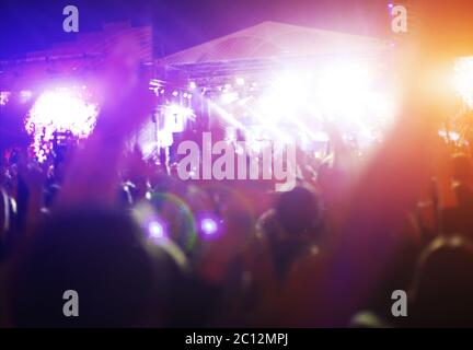 Sagome di concerto la folla di fronte luminose luci da palco Foto Stock