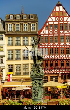 Statua una donna giudice con scale e spada con vecchie case tradizionali in legno nel centro di Francoforte, Germania Foto Stock