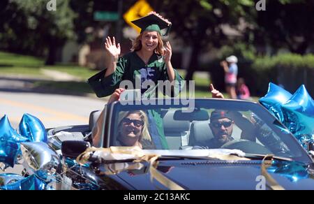 Bartlett, Illinois, Stati Uniti. 13 Giugno 2020. Bartlett High School Class di 2020 laureati ALEXIS GRABER corre in una parata drive-by che celebra la laurea attraverso Bartlett, Illinois. La pandemia del coronavirus ha interrotto le attività scolastiche e scolastiche da metà marzo. Credit: H. Rick Bamman/ZUMA Wire/Alamy Live News Foto Stock