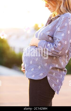 Donna incinta sullo sfondo della città Foto Stock
