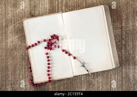 Rosario cattolico sul libro aperto Foto Stock