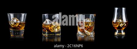 Set di quattro bicchieri di whisky o di altro tipo con ghiaccio cubico su sfondo nero Foto Stock