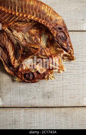 Pesce salato essiccato su legno. Foto Stock