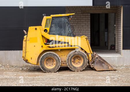 Minipala caricatrice sul cantiere Foto Stock