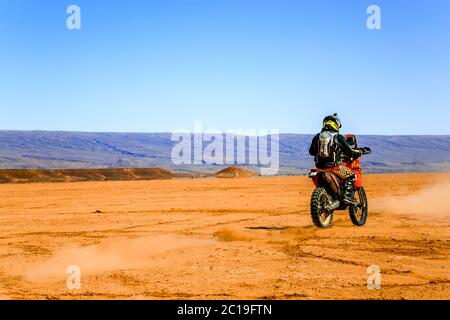 AIT Saoun, Marocco - 22 febbraio 2016: Vista rara dell'uomo in bicicletta a casco nel deserto di Ait Saoun del Marocco. Foto Stock