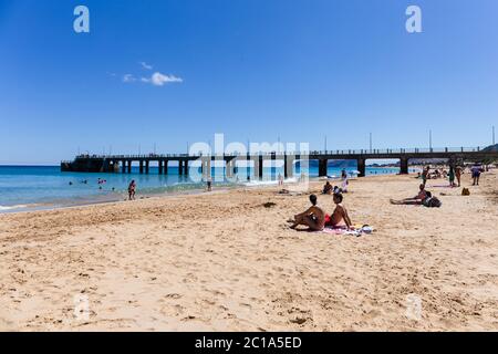 Porto Santo, Madeira, Portogallo - Giugno 2020: Turisti e locali facendo un bagno sulla spiaggia dell'isola di Porto Santo. Foto Stock