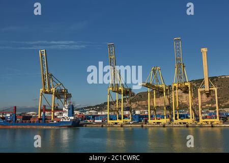 La gru portuale carica un container sul molo per il trasporto di esportazione di importazione a Barcellona Spagna Foto Stock