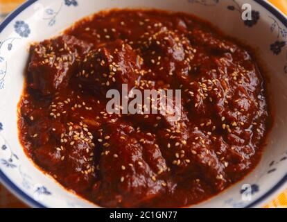 Pollo in salsa Mole Poblano di cioccolato piccante - famoso piatto tipico messicano da Puebla. (fuoco selettivo) Foto Stock