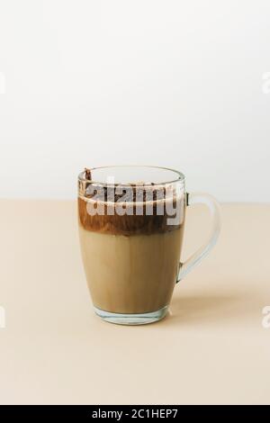Una tazza di caffè Dalgona sul tavolo giallo, primo piano Foto Stock