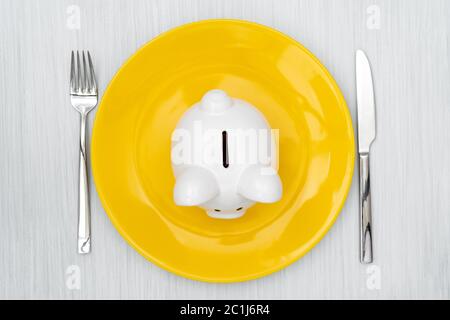 Banco di porcellini sul piatto da pranzo Foto Stock