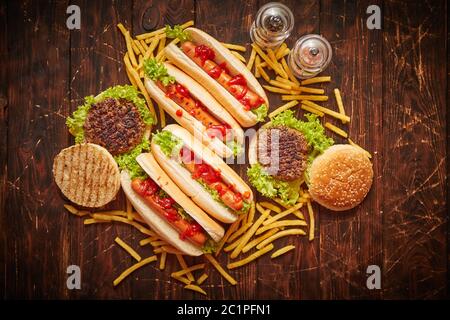 Hot dog, hamburger e patatine fritte. Composizione di spuntini fast food Foto Stock