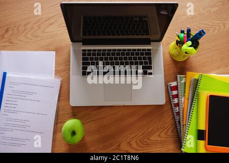 Laptop e mela verde sul tavolo. Foto Stock