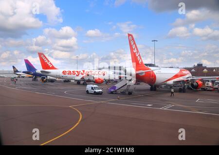 LUTON, Regno Unito - 12 LUGLIO 2019: Flotta di easyJet Airbus A319 con Wizzair e Ryanair in background all'aeroporto di Londra Luton, nel Regno Unito. È il quinto posto più trafficato del Regno Unito Foto Stock