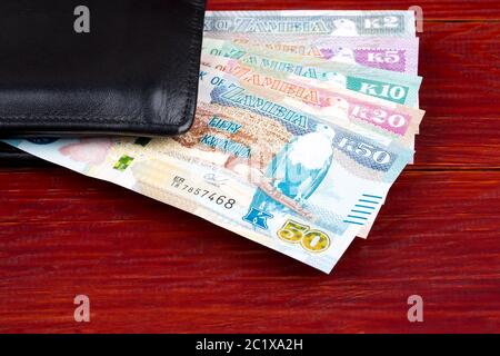 Il denaro da Zambia nella custodia nera Foto Stock
