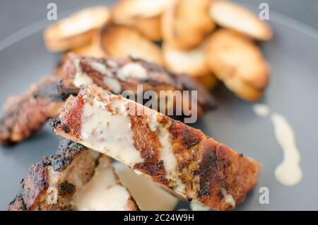 Spareribs sul grill con dip, tostate baguette Foto Stock