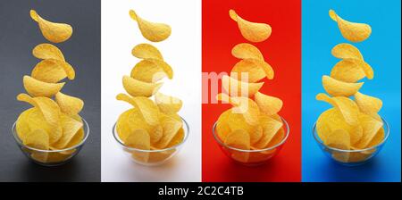 Potato chips di cadere nella ciotola di vetro isolato su sfondo bianco, volare le patatine Foto Stock