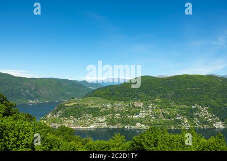 Aerail Vista su Morcote con Lago Alpino Lugano e montagna in una giornata di sole in Ticino, Svizzera. Foto Stock