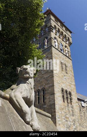 Scultura di un leone sulla parete animale e la Torre dell Orologio in background e il Castello di Cardiff, Cardiff, Galles del Sud. Foto Stock